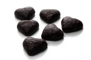 Decadent dark chocolate hearts delightfully arranged on a reflective surface for a sweet treat