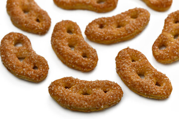 Sweet and crunchy snacks shaped like playful crescents on a bright surface