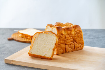 Sliced white bread on wooden board.
Delicious white bread image.

