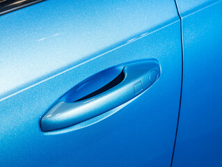 Close up of door handle in blue   car.