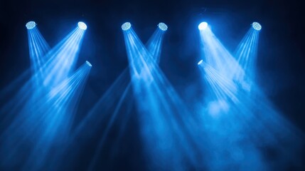 Blue stage spotlights illuminating smoky darkness.