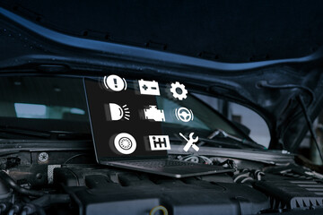Naklejka premium Open car hood with laptop placed on the engine, displaying virtual automotive icons for diagnostics and maintenance. Concept of modern vehicle inspection and repair using technology