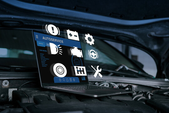 Laptop on car engine with floating diagnostic icons, representing modern vehicle diagnostics, repair, and digital maintenance