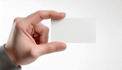 Obraz premium Male hand holding a blank card or a ticket/flyer, isolated on white background