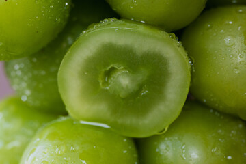 close up of green grapes with water
