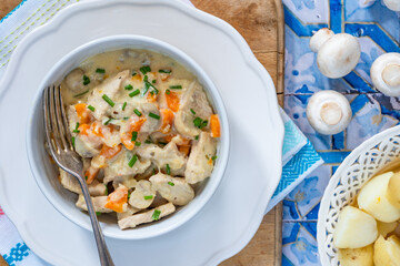 Pork in creamy mushroom sauce with boiled baby potatoes