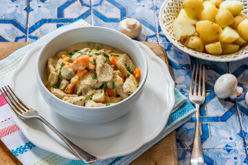 Pork in creamy mushroom sauce with boiled baby potatoes