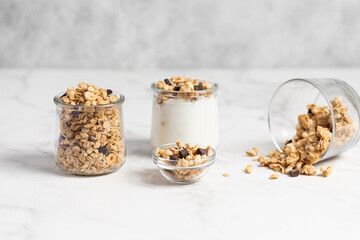 granola with chocolate, yogurt with granola in a glass jar