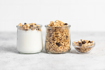 granola with chocolate, yogurt with granola in a glass jar