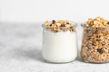 granola with chocolate, yogurt with granola in a glass jar