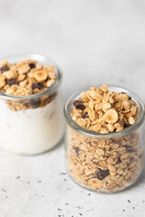granola with chocolate, yogurt with granola in a glass jar