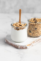 granola with chocolate, yogurt with granola in a glass jar