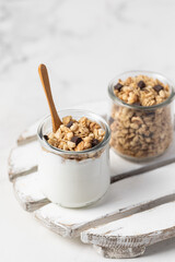 granola with chocolate, yogurt with granola in a glass jar