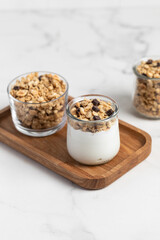 granola with chocolate, yogurt with granola in a glass jar