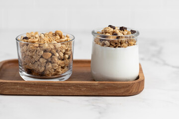 granola with chocolate, yogurt with granola in a glass jar