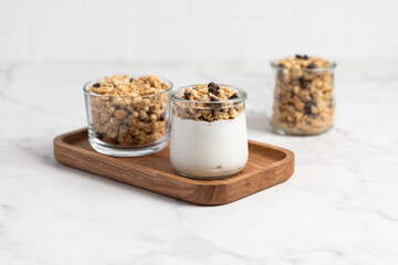 granola with chocolate, yogurt with granola in a glass jar