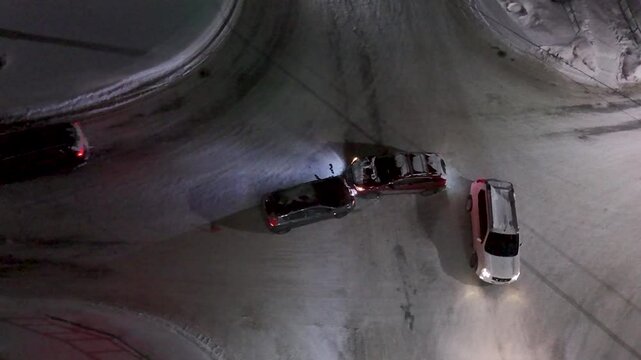 Road accident at night at an intersection in winter. View from above.
