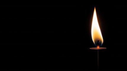 Fototapeta premium Candle flame glowing brightly dark background