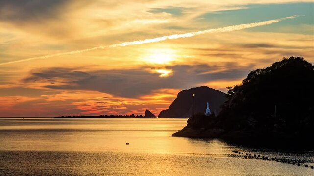 秋の海上マリア像と夕日　タイムラプス　熊本県天草市　Autumn sea statue of Mary and sunset. time lapse. Kumamoto Pref, Amakusa City.