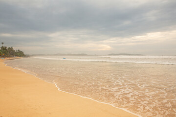 Surfing Paradise and golden beach in Weligama coast of indian ocean in Sri Lanka. A favorite destination for travelers seeking both relaxation and adventure.