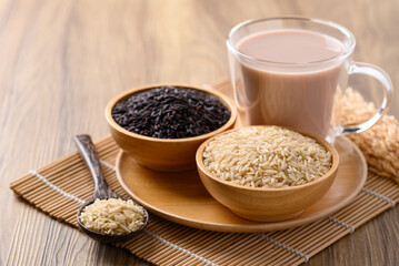 Organic rice milk in cup glass on wooden background, Alternative milk made from plant, non dairy