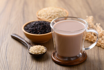 Organic rice milk in cup glass on wooden background, Alternative milk made from plant, non dairy