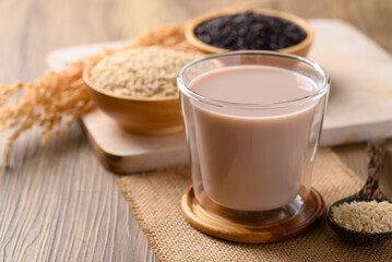 Organic rice milk in cup glass on wooden background, Alternative milk made from plant, non dairy