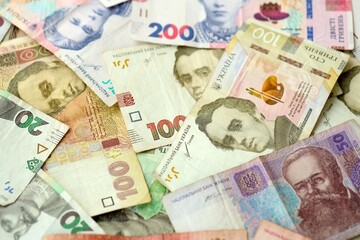 Big amount of different ukrainian hryvnia currency money bills in pile