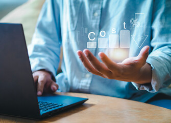 Businessman working on digital tablet with growth graph of quality control cost reduction and quality control. Business strategy and project management concept.