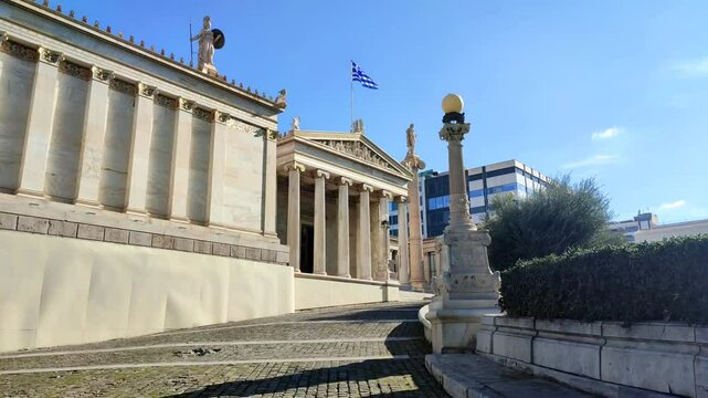 Exterior view of the Academy of Athens, the jewel of Theophil Hansen&rsquo;s Neoclassical Trilogy, standing proudly on Panepistimiou Avenue in downtown Athens.