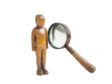 Isolated Wooden Figure with Magnifying Glass