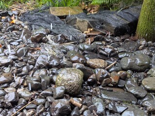 Wet rocks are showered by very heavy rain