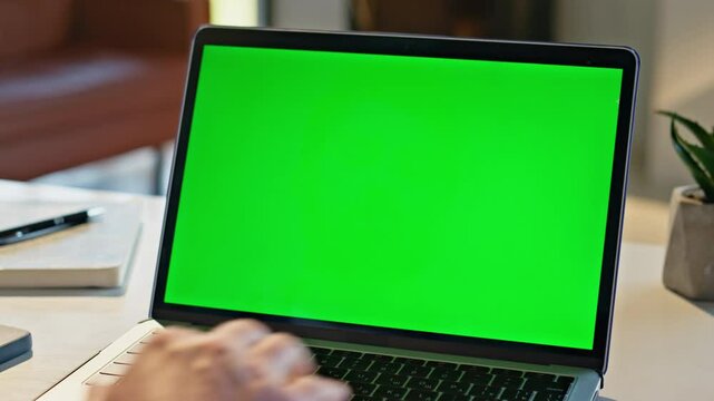 Unknown man typing greenscreen laptop at kitchen closeup. Freelancer working