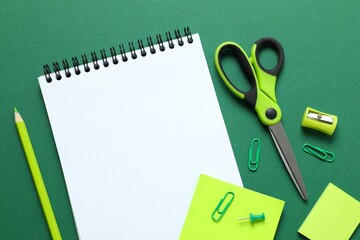 Flat lay with school stationery and noyebook on color background, top view