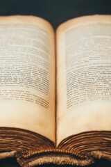 Fototapeta premium A close-up of an open book page, showing the fine print and aged paper,