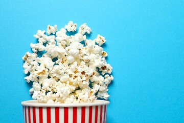 Delicious popcorn on colored background