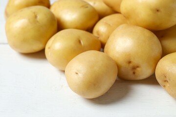 Young potatoes. Fresh potatoes on a wooden background. Harvesting collection. organic, freshly dug potatoes. Agricultural background. Vegan. Vegetables.Place for text.Copy space