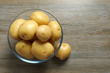 Young potatoes. Fresh potatoes on a wooden background. Harvesting collection. organic, freshly dug potatoes. Agricultural background. Vegan. Vegetables.Place for text.Copy space