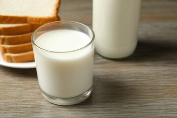 Glass of milk with bread on the table