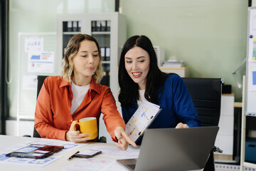 Diverse designer collaborate on project analysis with financial graphs. Strategic teamwork and...