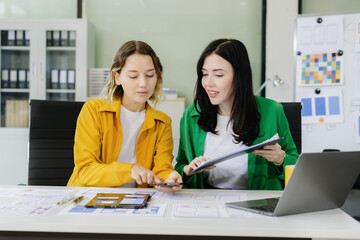 Diverse designer collaborate on project analysis with financial graphs. Strategic teamwork and insights drive company growth and success.