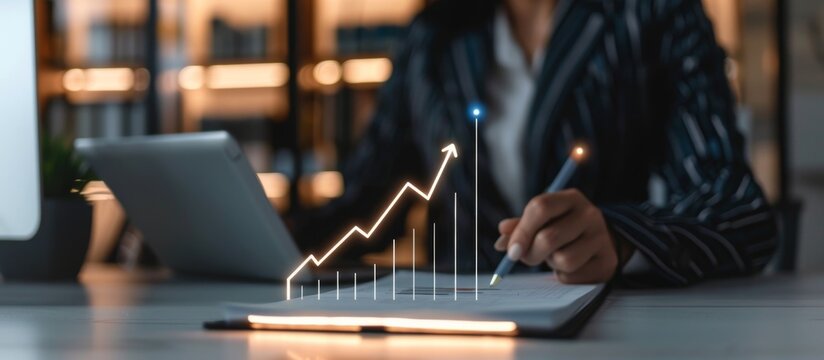 In a modern office setting, a business professional is carefully examining a financial growth chart on a tablet and notebook, focusing on data analysis and strategic business growth - Powered by Adobe