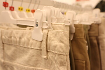 A modern and stylish pants rack display featured in a trendy fashion store setting