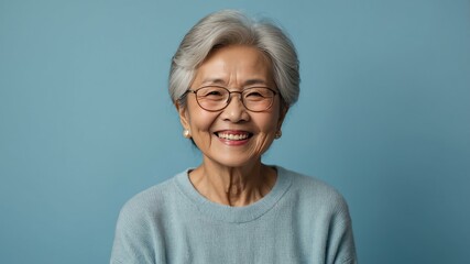 elderly asian female in casual wear on pastel background model portrait smiling for ad concept space for text