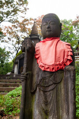 Ueno Daibutsu pagoda at Great Buddha Hill with a Jizo buddha statue in Ueno Park, Tokyo, Japan.