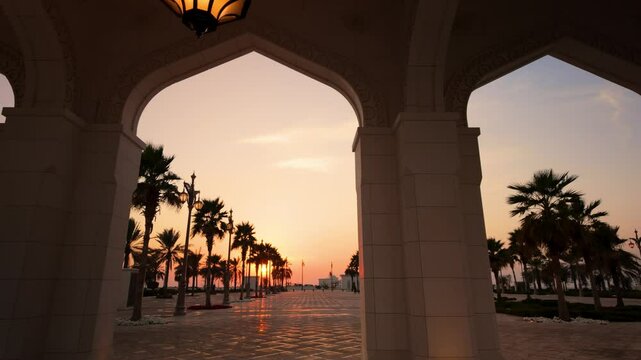 Golden sunset seen from the arches of a resort or palace in the Middle East