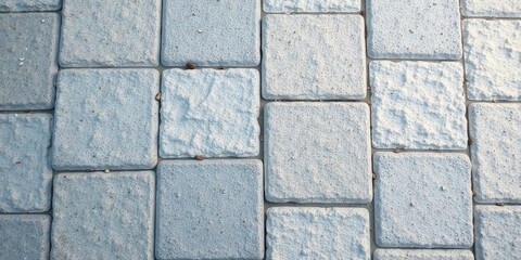 Fototapeta premium Textured Stone Pavement A Detailed Close-Up View of Interlocking Grey Paving Stones