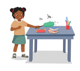 Cute little African girl cleaning table with feather duster