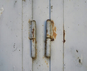 Close-Up of Rusty Hinges on a Weathered Metal Door
