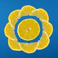 Lemon slices arranged in a circular pattern on a blue background